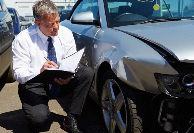 white car parked with insurance coverage displayed